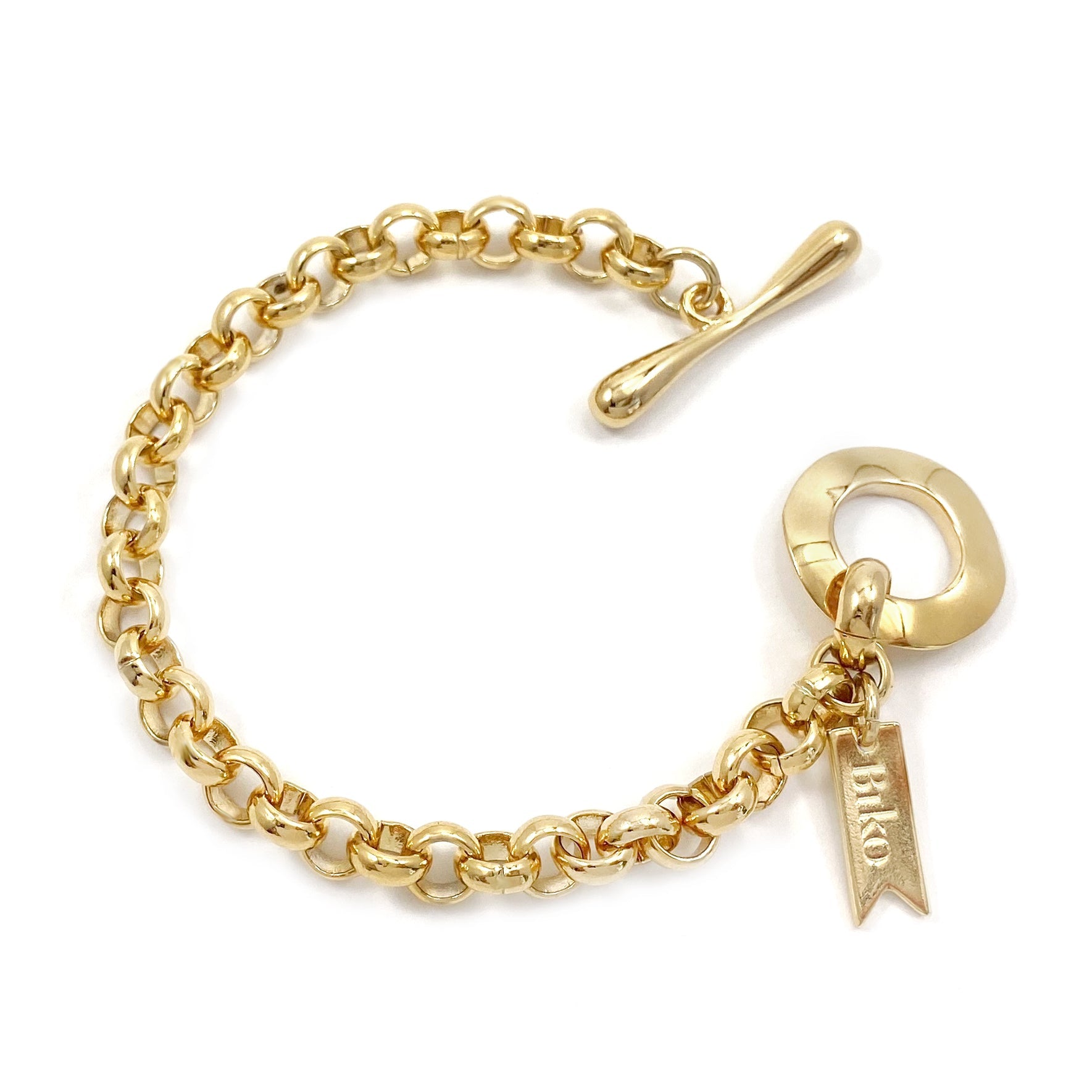 Gold chain bracelet with toggle clasp, engraved tag and dangling charm