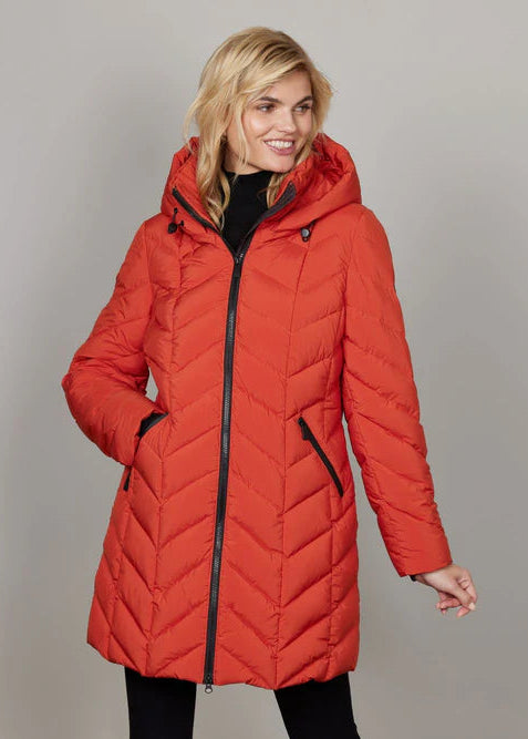 Woman wearing a red puffer coat against a plain background
