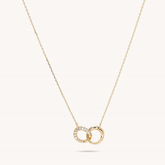 Gold interlocking double circle pendant necklace with diamond-set ring on delicate chain