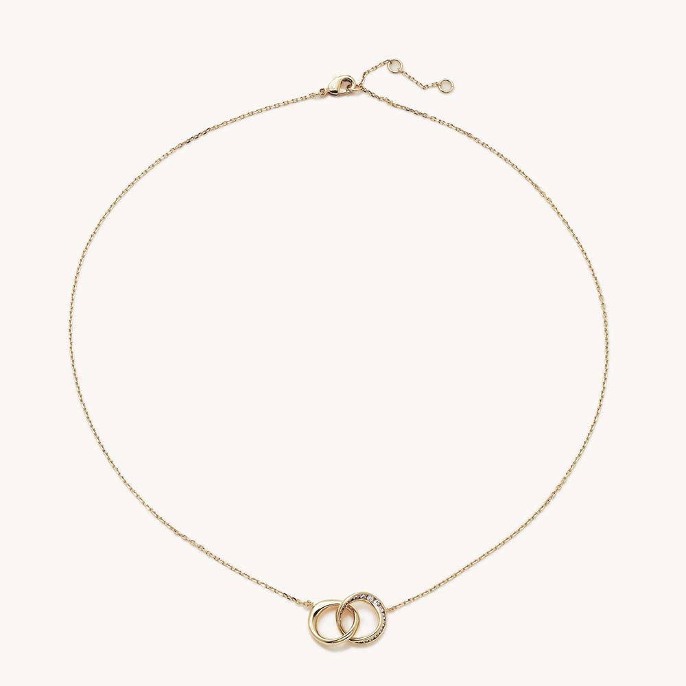 Gold necklace with two interlocking circles pendant, one plain and one pavé white crystal