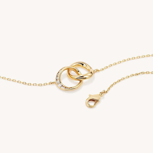 Gold interlocking double circle pendant bracelet with pavé white crystal accents and lobster clasp
