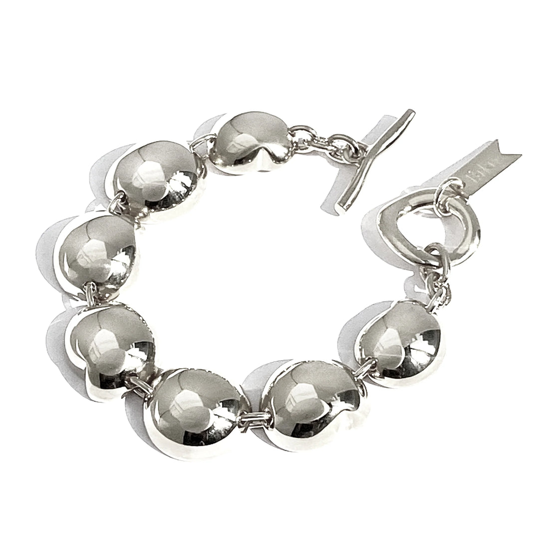 Silver ball-link bracelet with round charms and toggle clasp