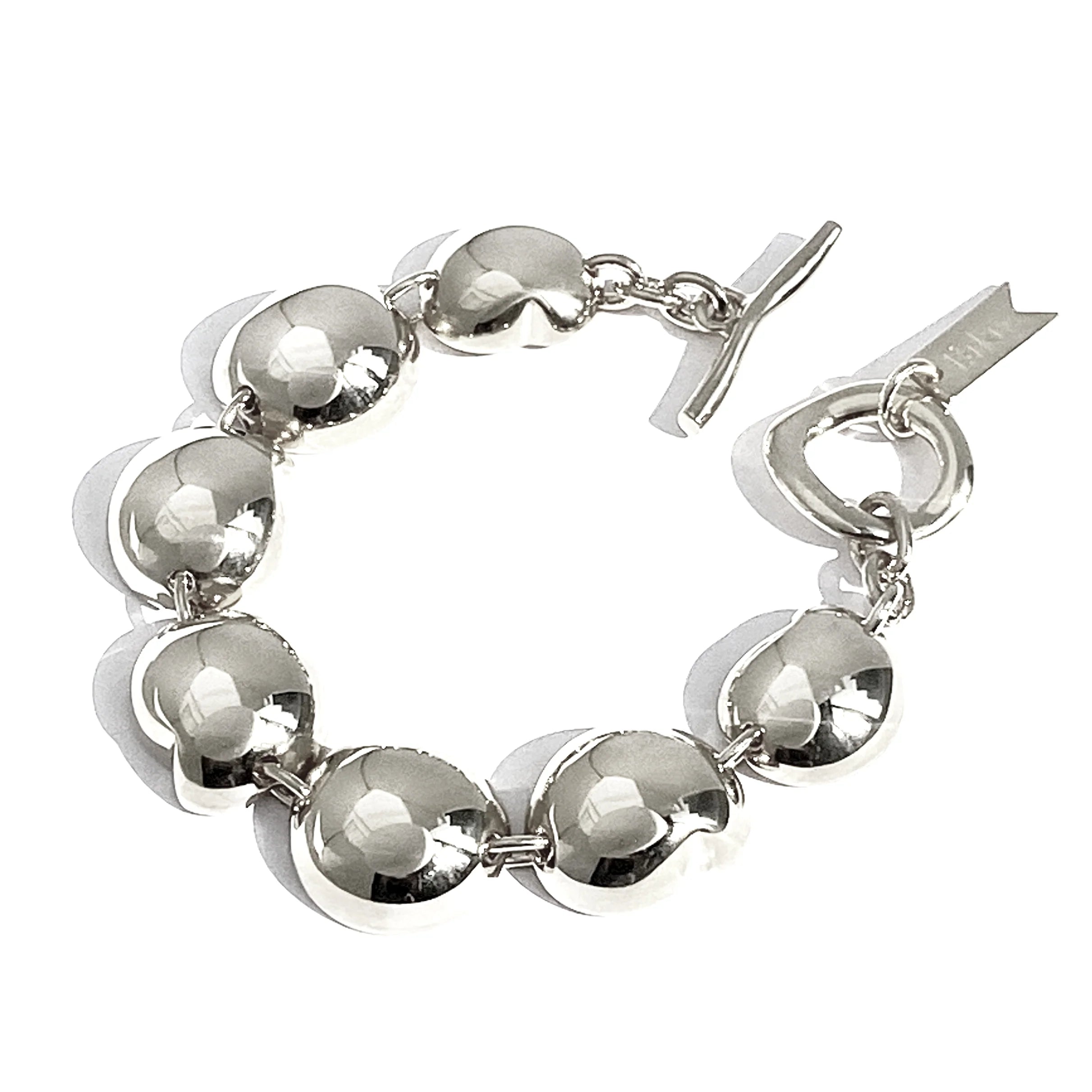 Silver ball-link bracelet with round charms and toggle clasp
