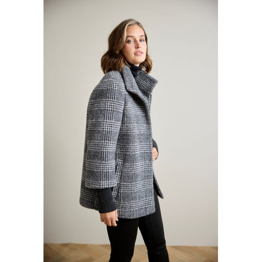 Glen plaid wool coat with ribbed sleeve cuffs and high collar, side view on model