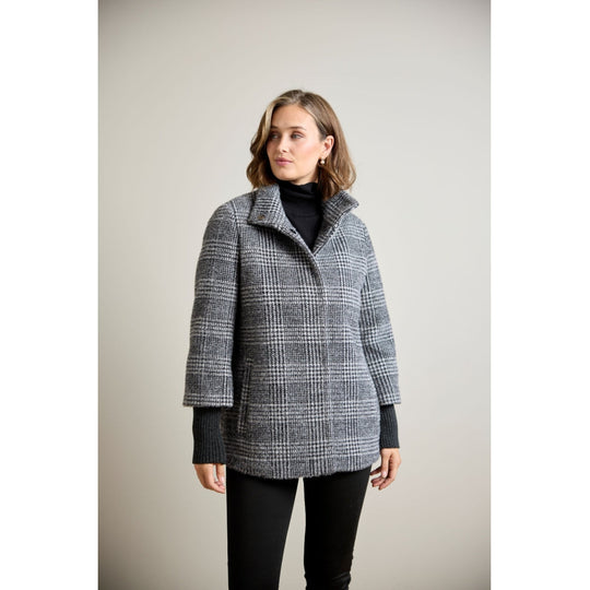 Glen plaid wool coat with ribbed sleeve cuffs and funnel collar, front view on model