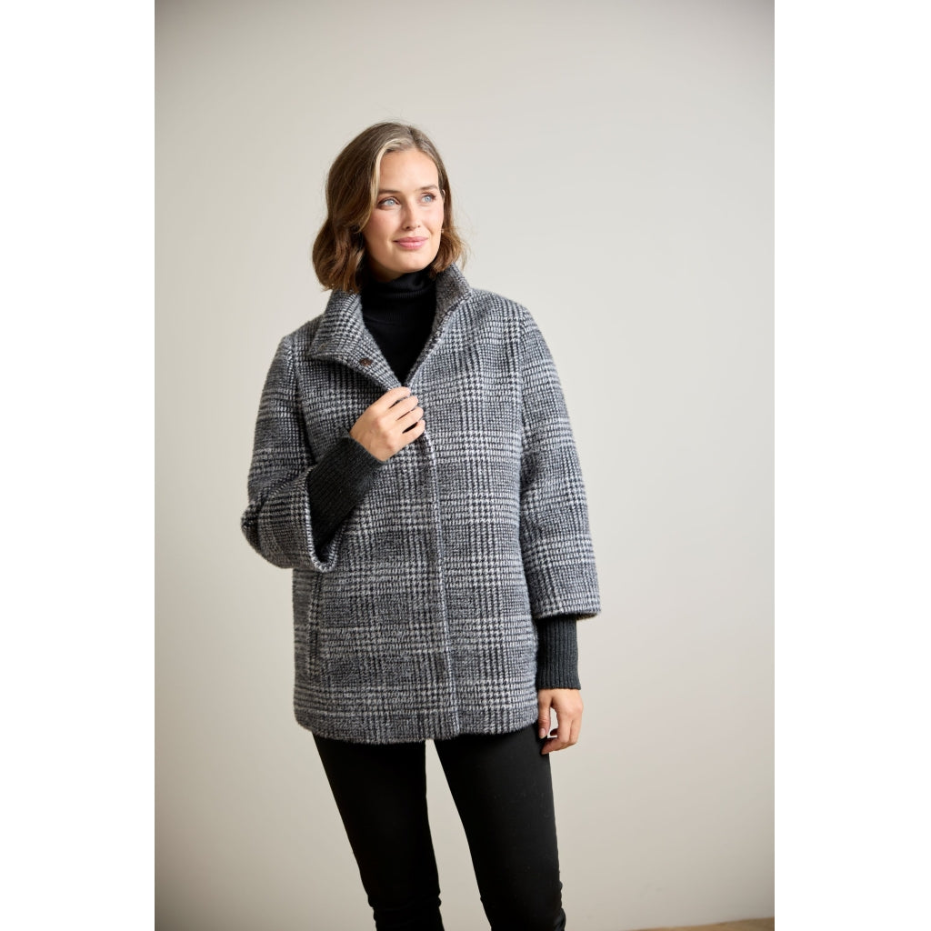 Oversized glen plaid wool coat with ribbed sleeve cuffs and wide collar, front three-quarter view
