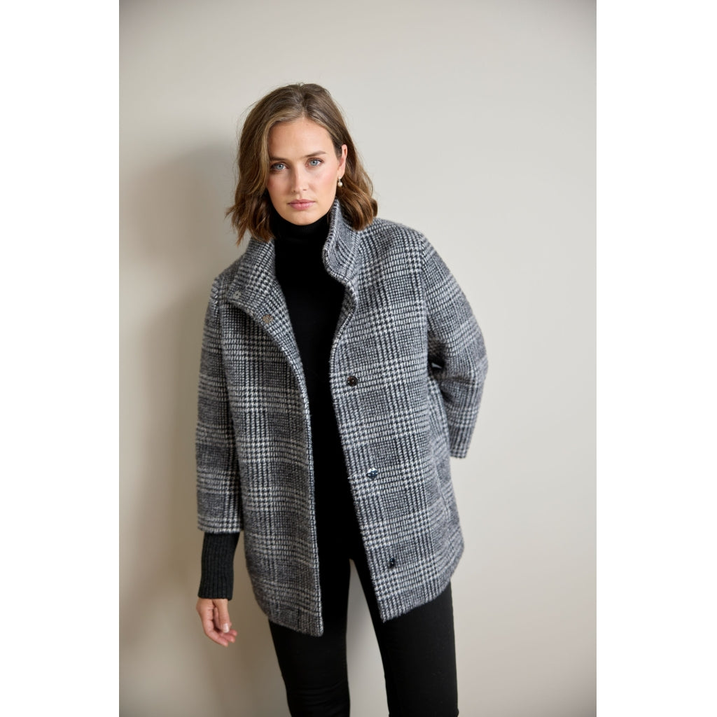 Oversized glen plaid coat with ribbed sleeve detail and stand collar, front view on model