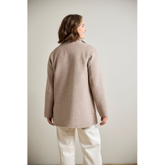 Taupe wool coat rear view on model, showing back seam, patch pockets, and relaxed fit