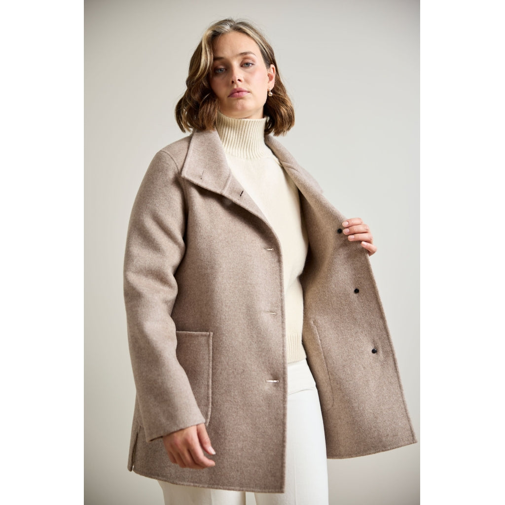Taupe double-face wool coat with patch pockets and side slits, open front view on model