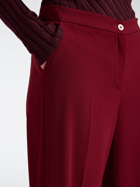 Men's deep red stretch crepe trousers detail with button closure and pocket seams