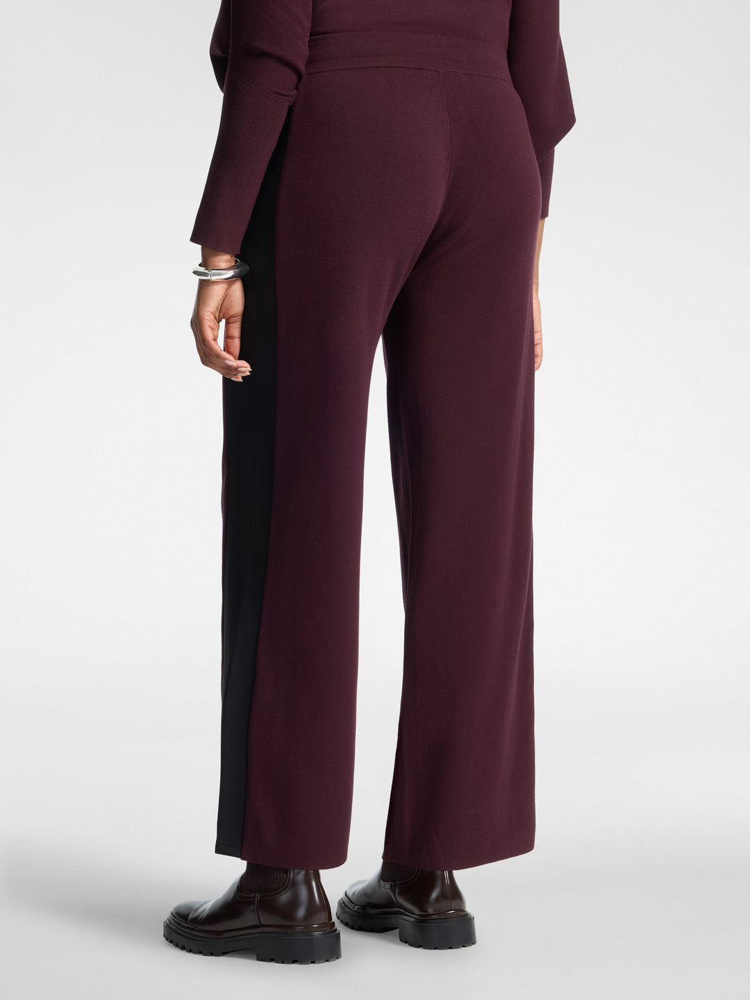 Women's viscose athletic trousers in dark plum with black side insert and drawstring.