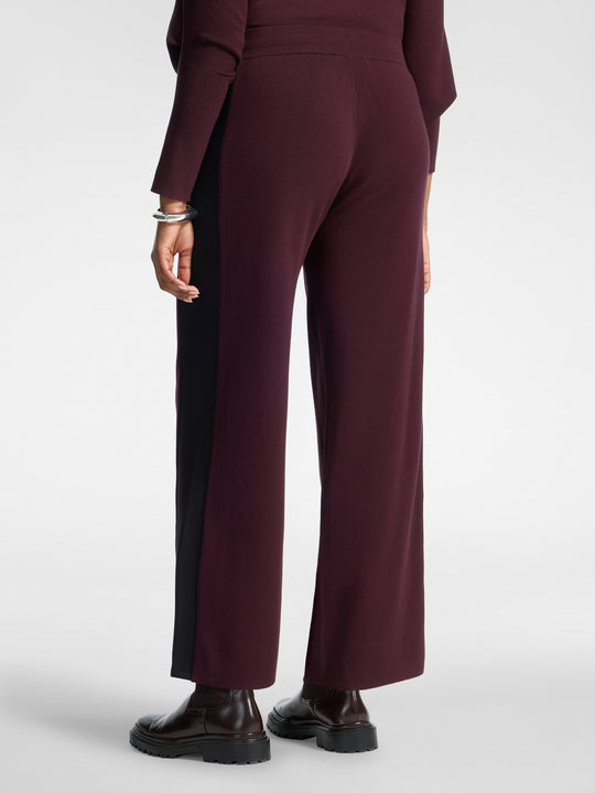 Women's viscose athletic trousers in dark plum with black side insert and drawstring.