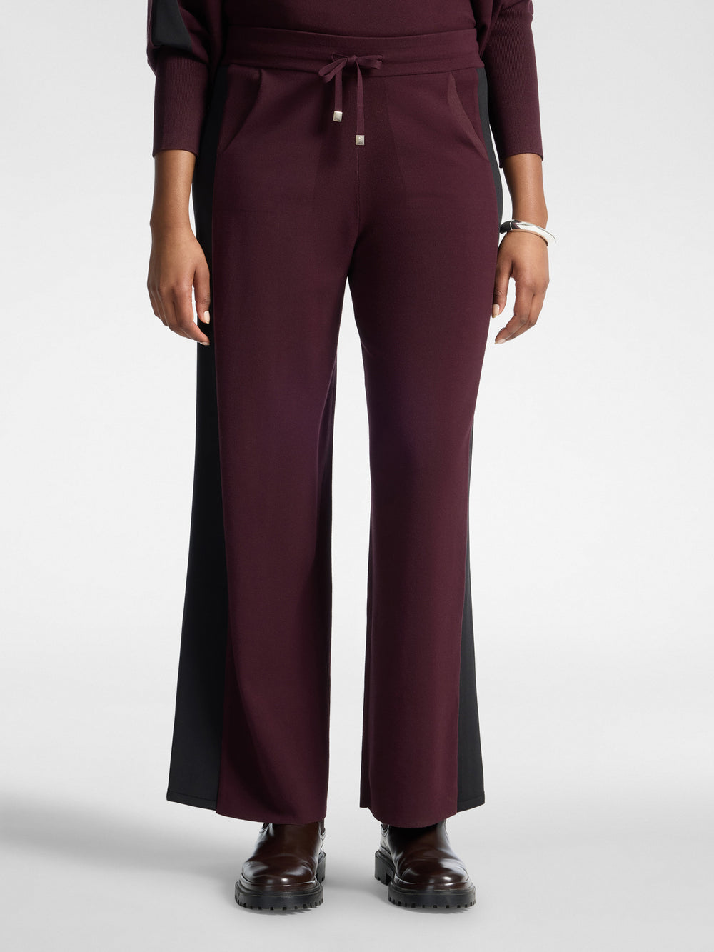Women's viscose athletic trousers in dark plum with black side insert and tie-front drawstring.