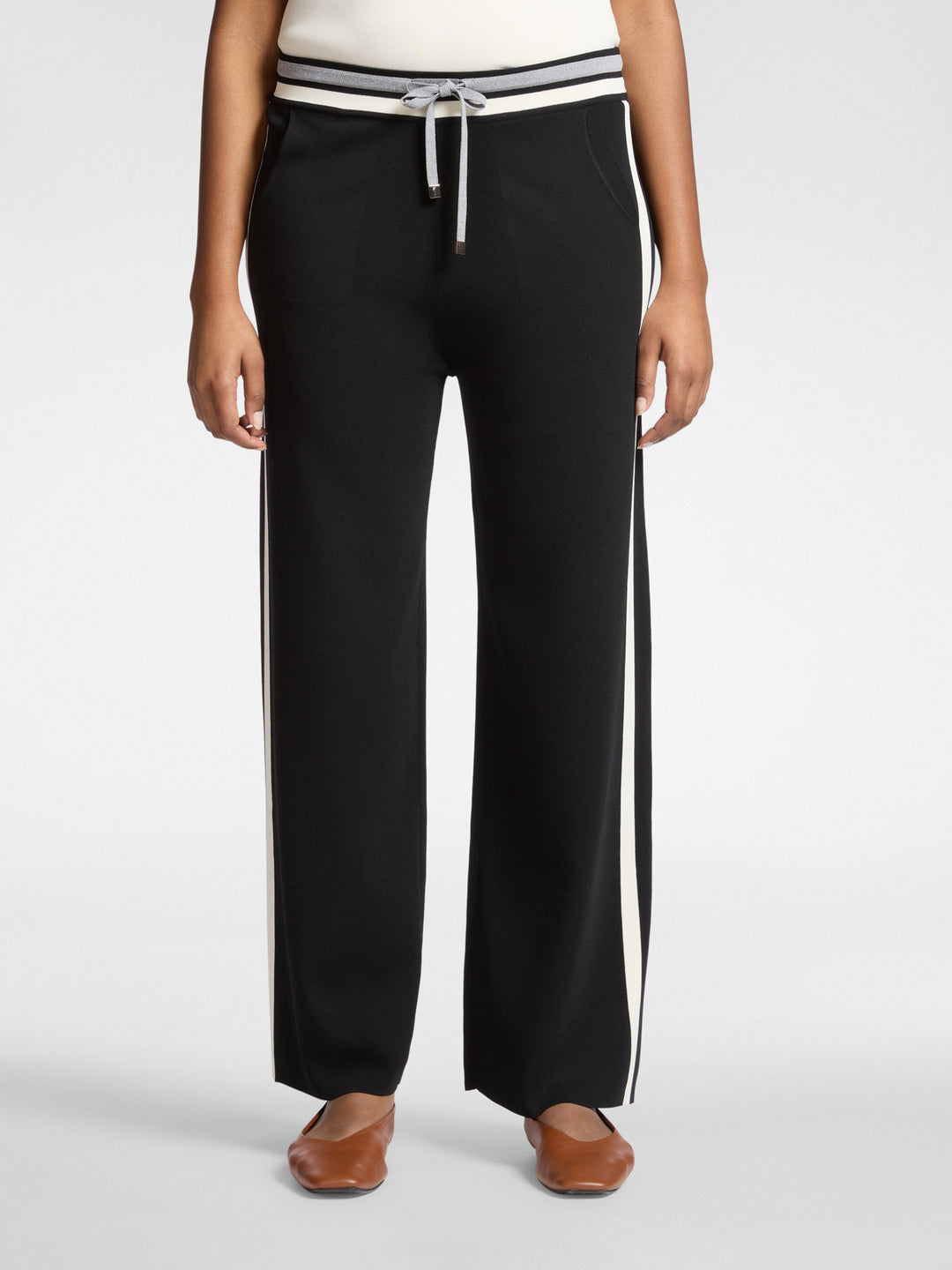Black wide-leg drawstring pants with white side stripes and ribbed banded waist