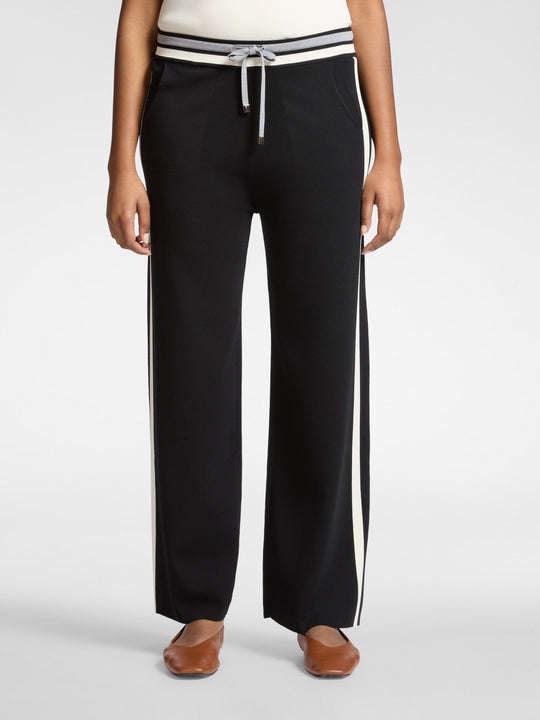 Black wide-leg drawstring pants with white side stripes and ribbed banded waist