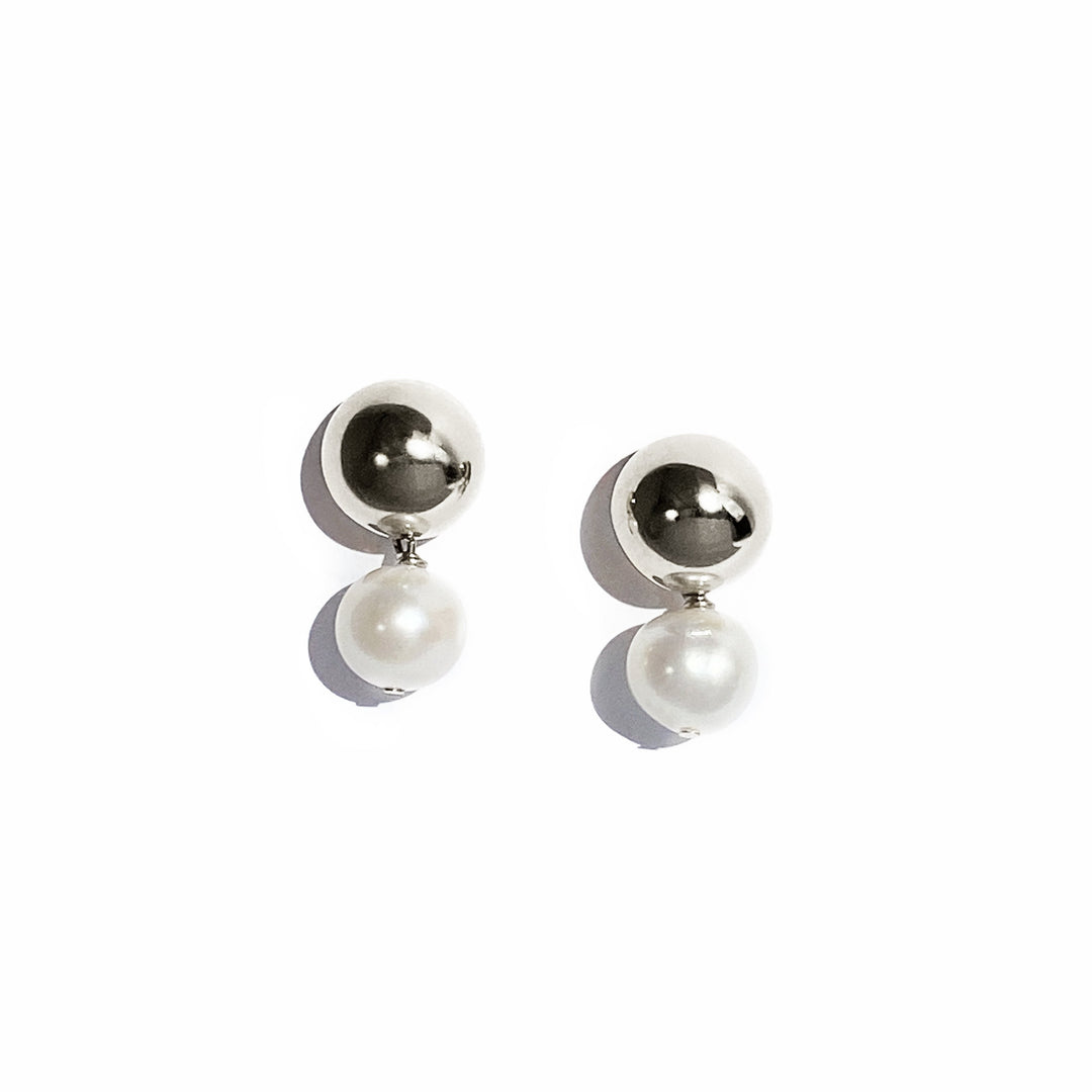 Silver stud earrings with domed tops and white pearl drops on white background