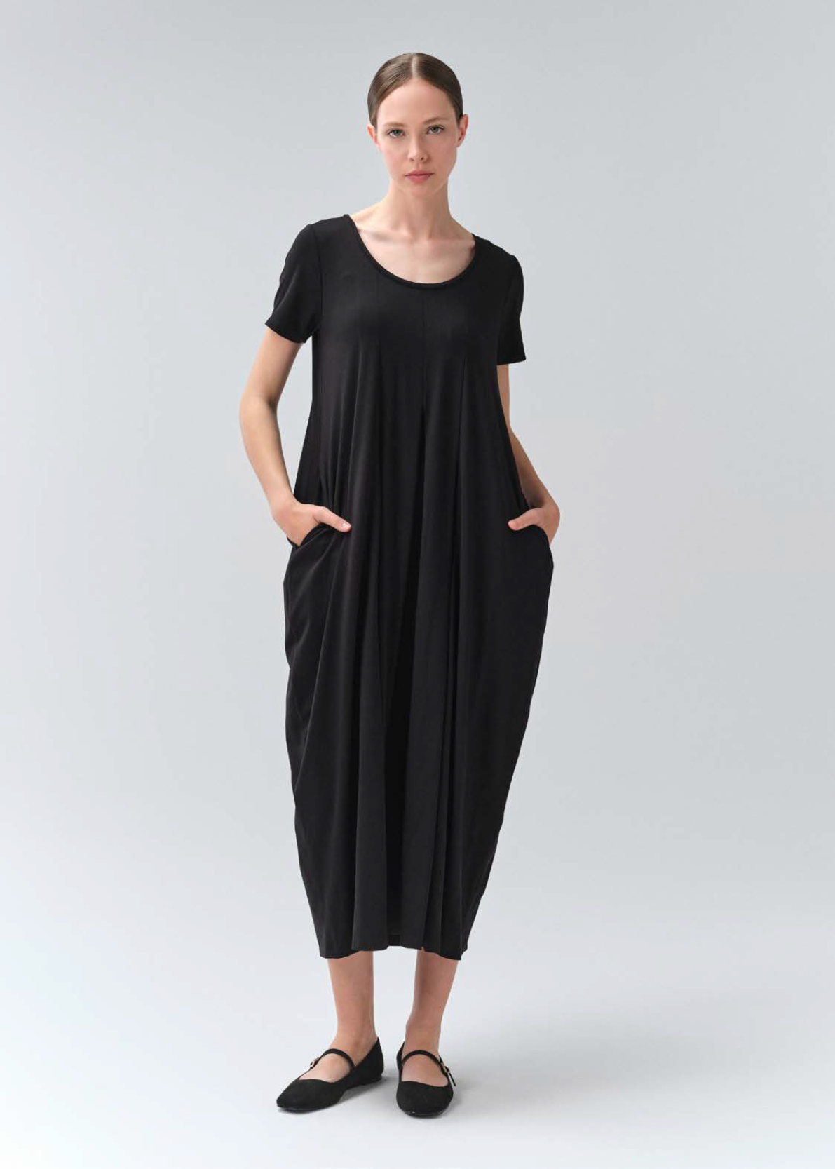 Woman wearing a black dress on a white background
