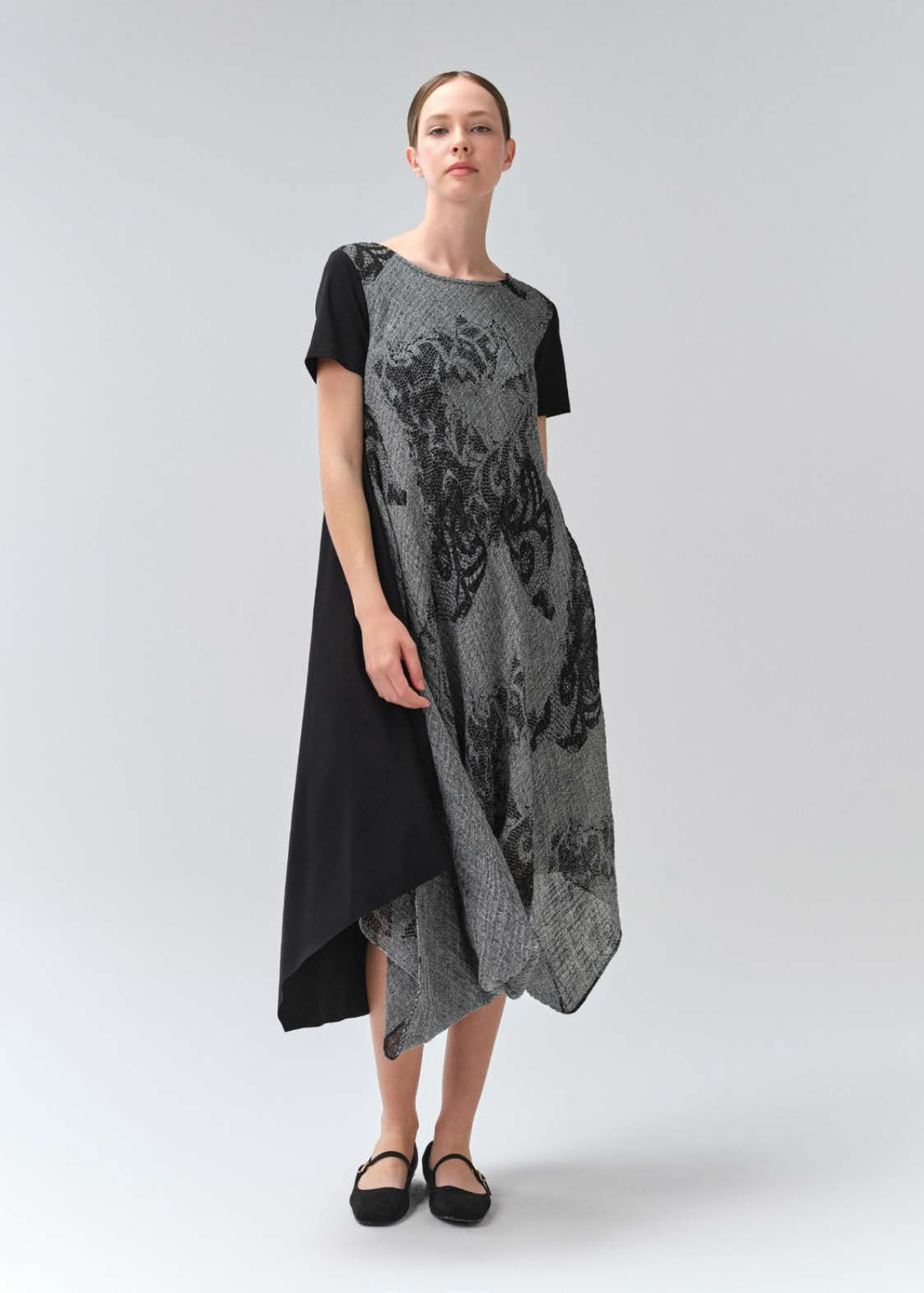 Woman wearing a black and gray dress on a white background