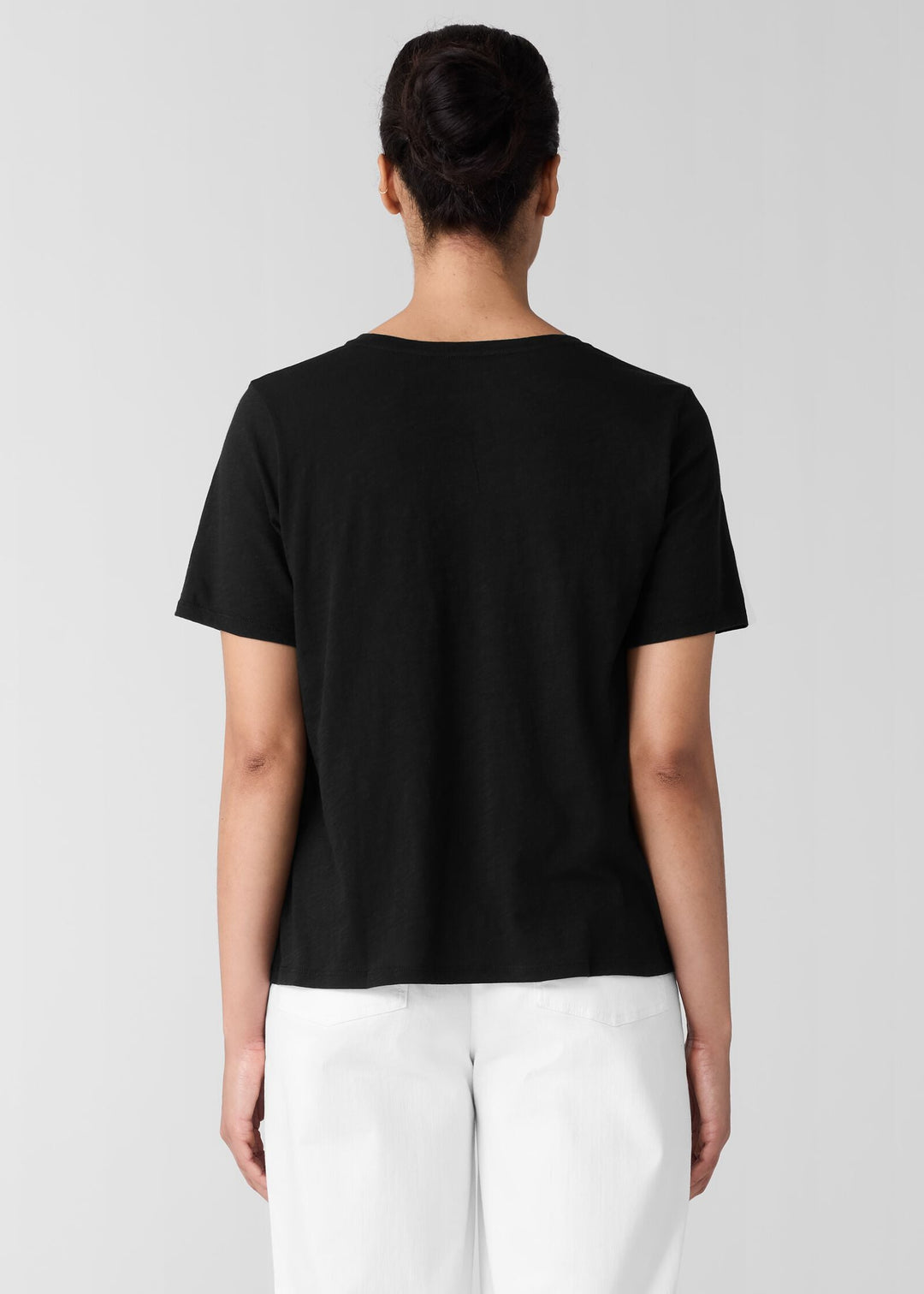 back view of plus size Eileen Fisher Organic Cotton Slubby Jersey V-Neck Short Sleeve Tee in Black