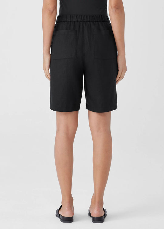 back view of Eileen Fisher Organic Linen zip front Elastic Waist plus size Shorts in Black