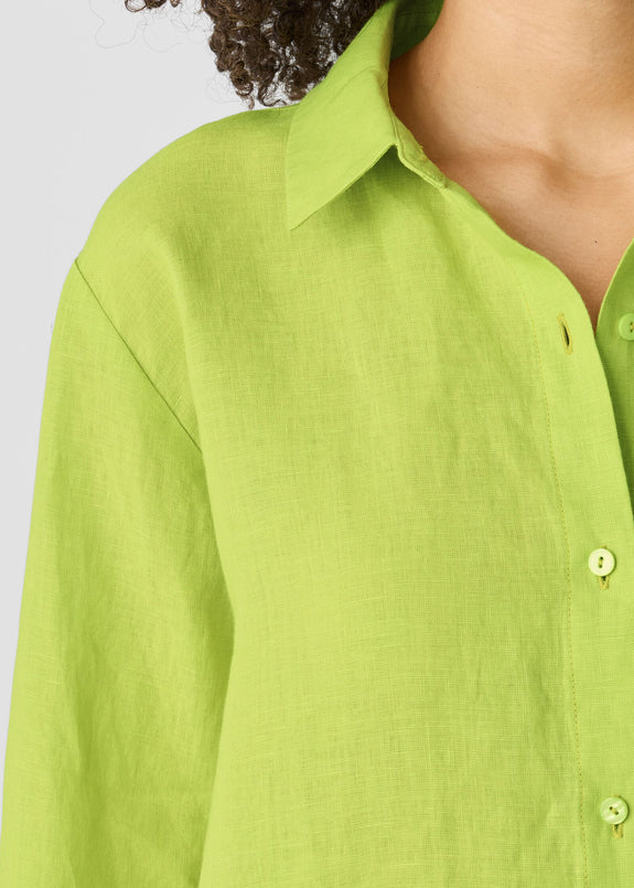 close up front view of Eileen fisher classic collar long sleeve button front organic linen pus size shirt in chartreuse