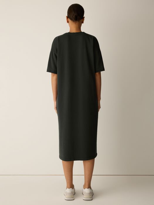 Dark green crew-neck elbow-sleeve dress, back view, side slit at hem