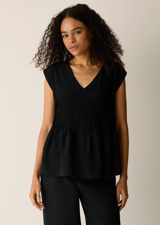 Black sleeveless v-neck top with pintuck pleating detail on front bodice