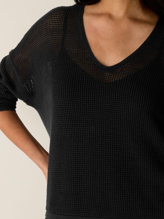 Black open-knit V-neck sweater close-up knit texture, breathable open weave.
