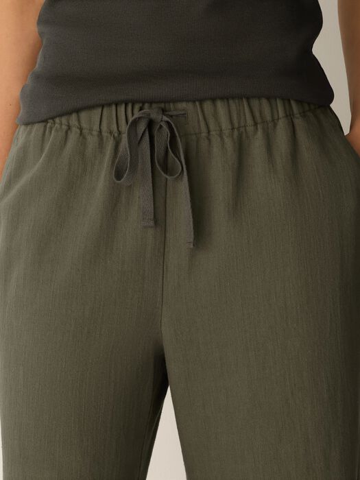 Olive elastic-waist pants with tied drawstring and pocket seams