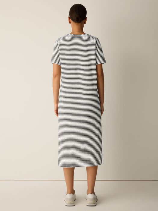 Back view of green-and-white striped midi dress, round neck and short sleeves