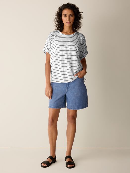 Woman wearing striped short sleeve box top with relaxed fit and crew neckline