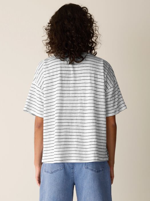 Striped short sleeve boxy top with horizontal black lines on white fabric, back view