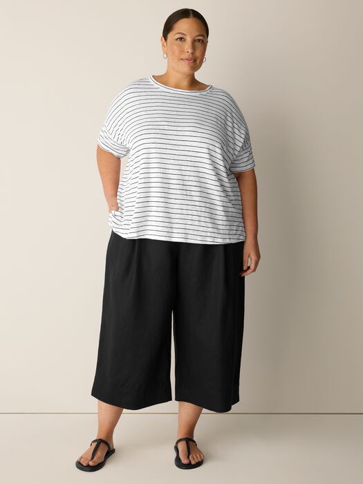 Striped short sleeve crew neck top with relaxed fit, worn with black wide-leg cropped pants