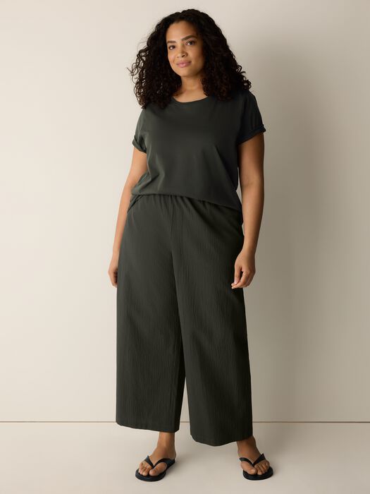 Seaweed green wide-leg ankle pants on model with elastic waistband