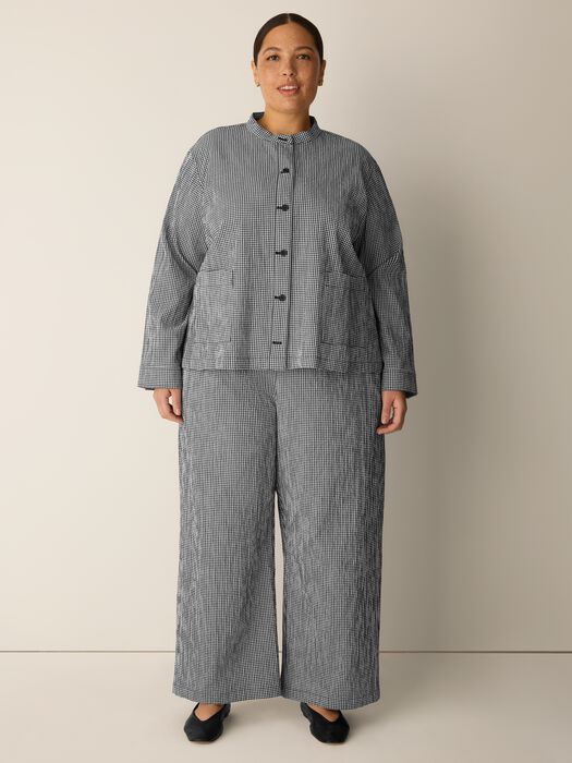 Woman wearing black and white checkered wide leg pants with matching button-up jacket