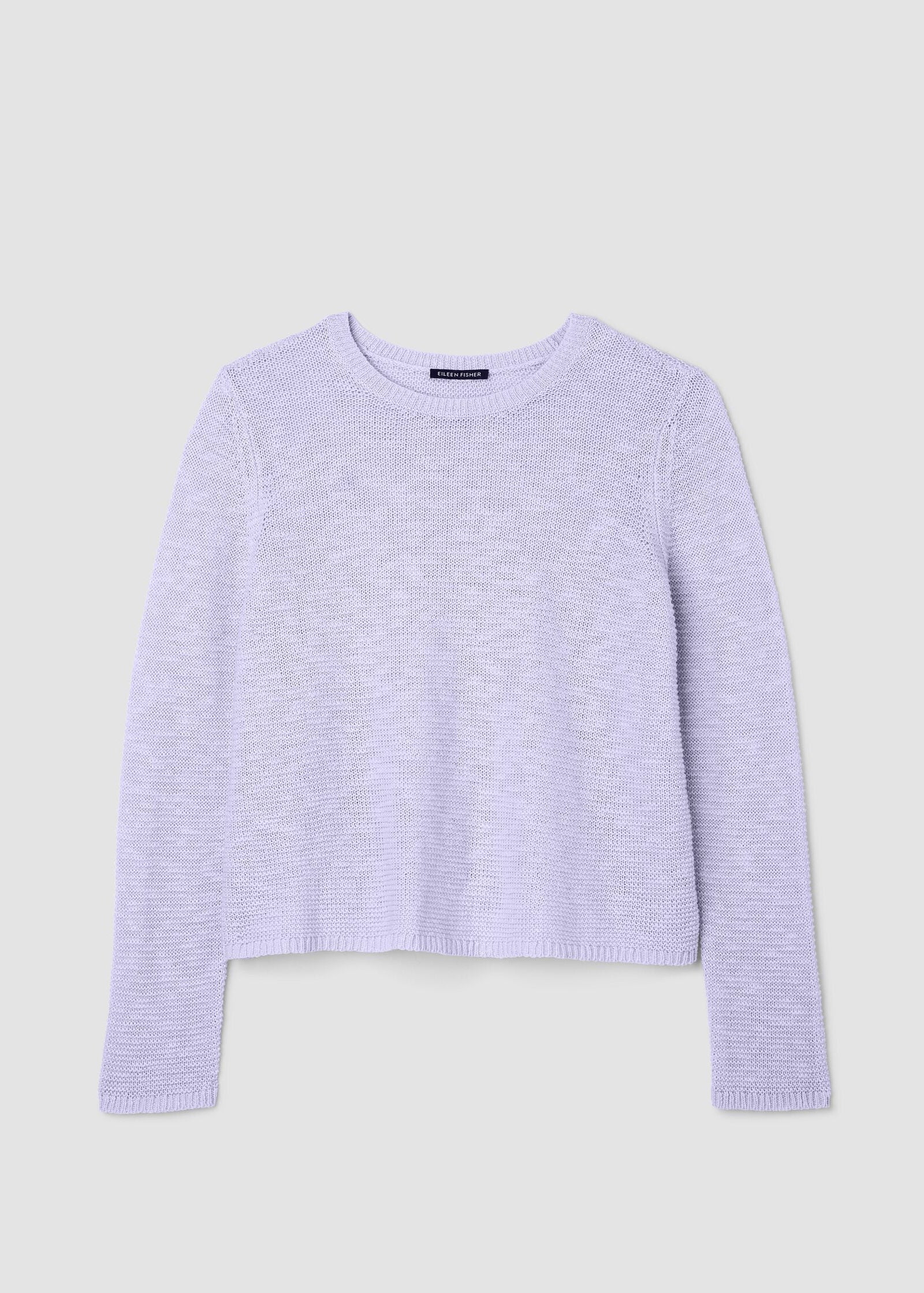 Light purple sweater on a light gray background