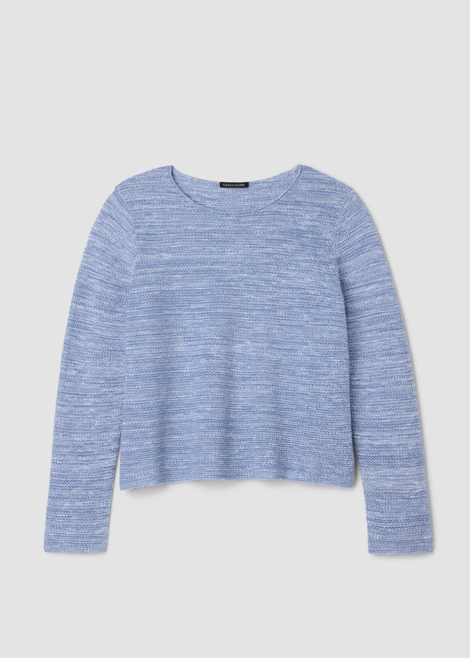 Blue knitted sweater on a light gray background