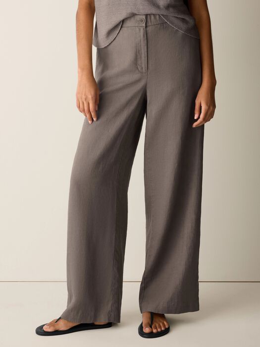 High-waisted wide leg linen trousers in warm brown, full length view on model