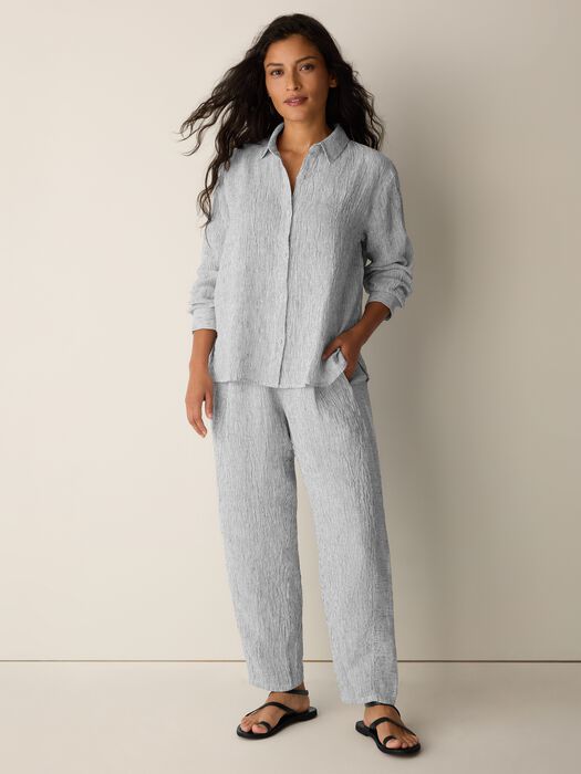 Striped linen shirt and matching pants set worn by model in studio setting