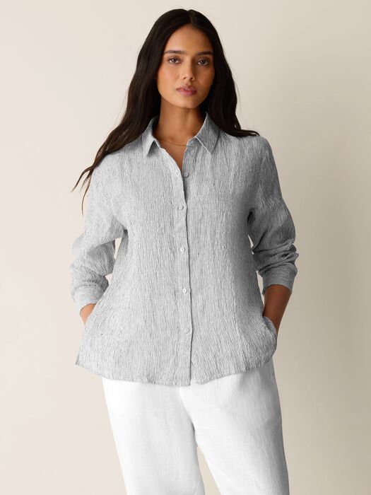 Gray and white striped linen shirt with classic collar and button front on model