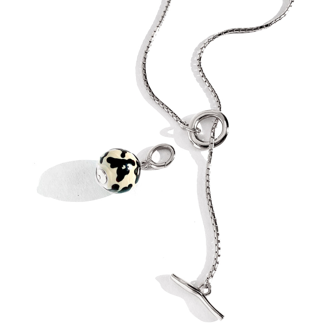 Silver chain necklace with toggle clasp and black white spotted charm pendant