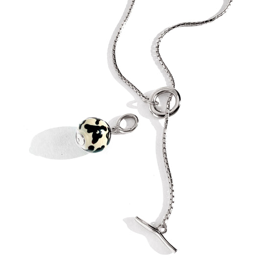 Silver chain necklace with toggle clasp and black white spotted charm pendant