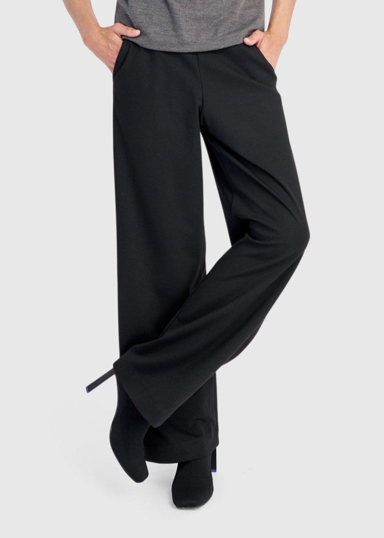 Black pull-on jersey pants with side pockets and relaxed wide legs