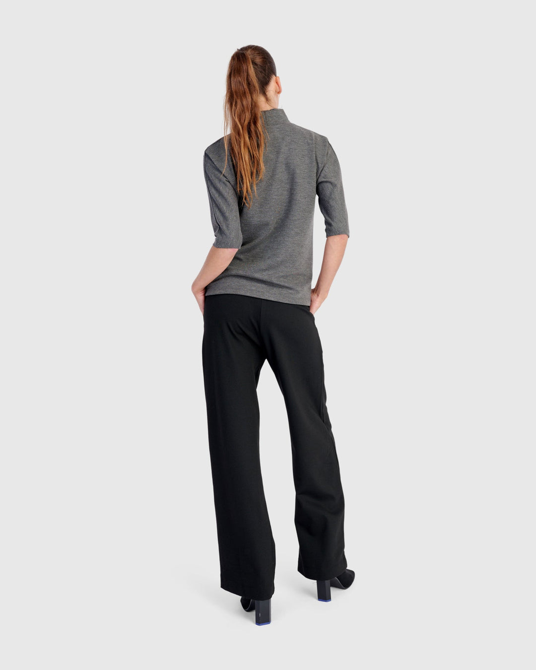 Wide-leg black pull-on pants shown from behind on a model, full length view