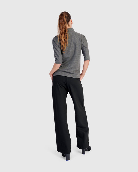 Wide-leg black pull-on pants shown from behind on a model, full length view