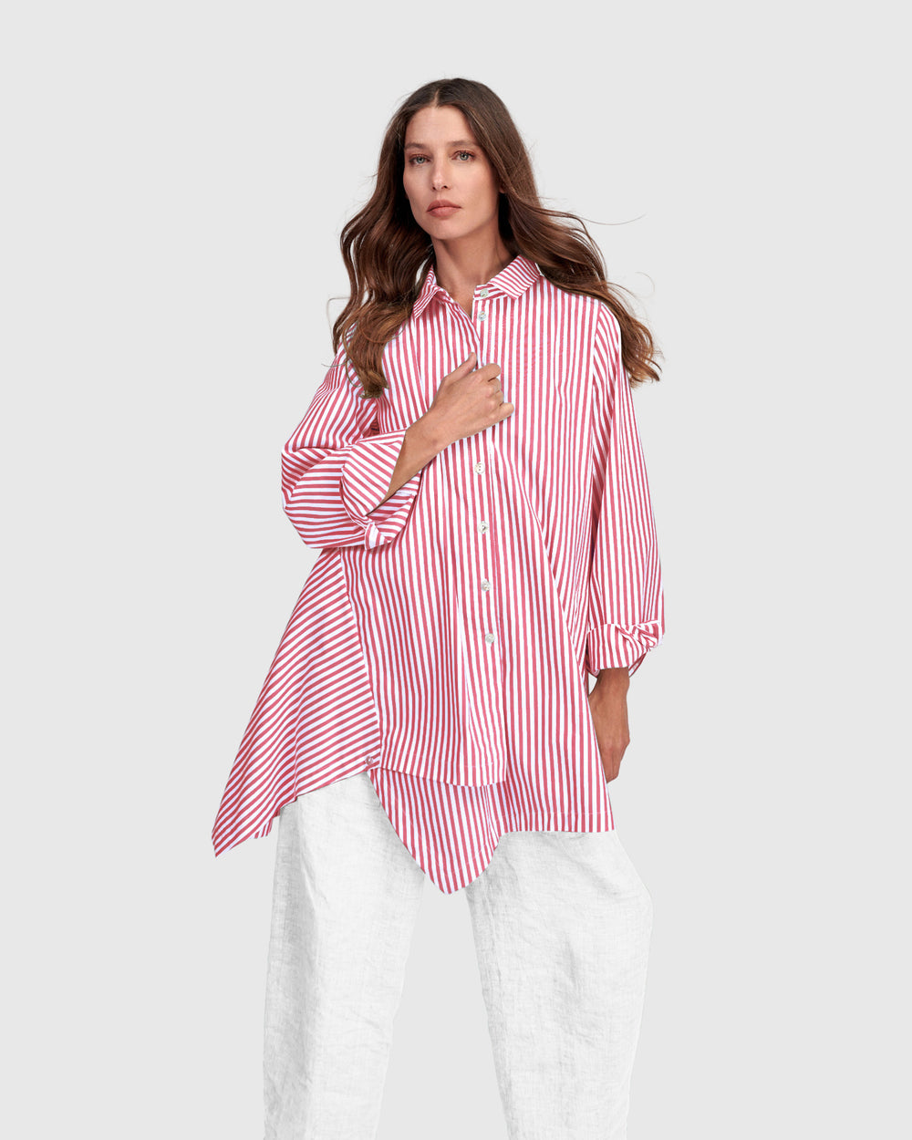Pink striped cotton shirt with point collar, button front, and handkerchief-style hem