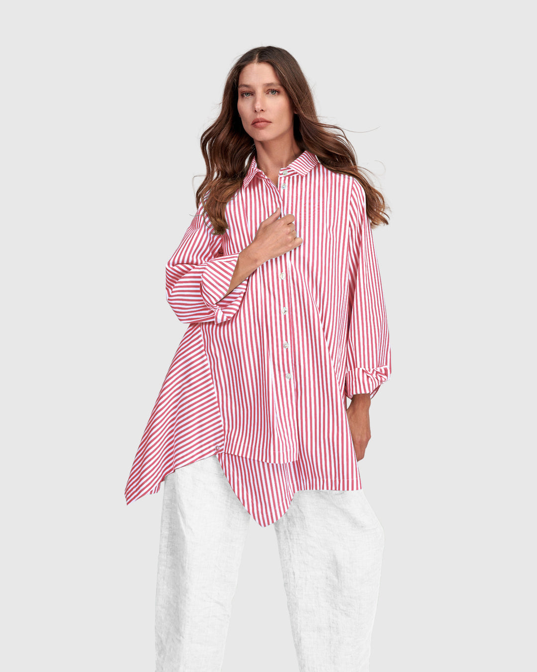 Pink striped cotton shirt with point collar, button front, and handkerchief-style hem