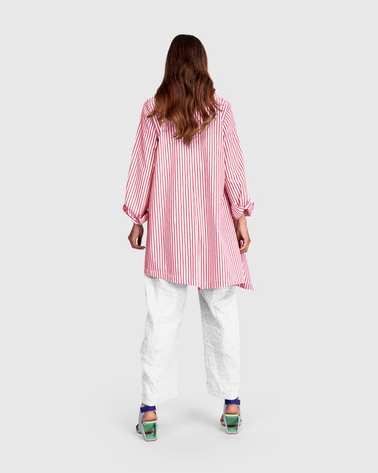 Back view of pink striped cotton shirt with point collar, long sleeves, asymmetrical hem