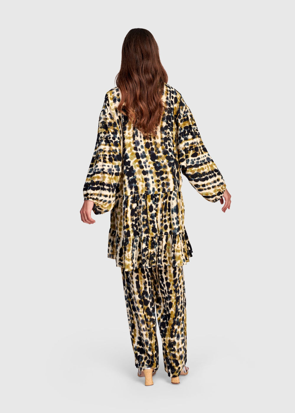 back view of plus size Alembika Trail Animal Print Tiered Button Front Tunic with Ruffle in Trails print