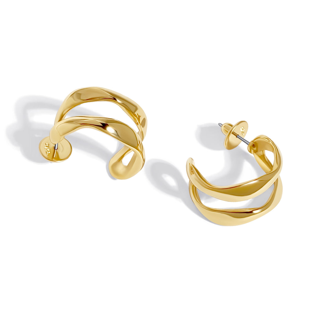 Gold twisted double band hoop earrings with open cuff design against white background